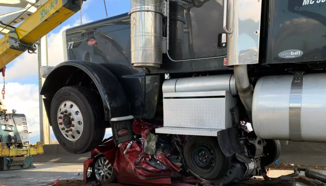 IKKE HELT SMADRET: Den kvinnelige sjåføren av den røde personbilen fikk bare mindre skader. Trailersjåføren fikk 189 dollar i bot.